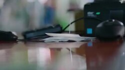 Sales associate spikes receipt on ticket spindle by cash register Stock Footage