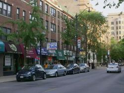 WS Street lined with shops day Stock Footage