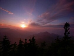 T/L sun setting over valley in the Shiga Kogen mountains, Japan Stock Footage
