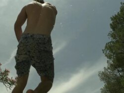 High Speed Man jumping into rock pool, low angle from behind, Spain. (Individual frames may also be used as a still image. Each frame in its raw state is about 6MB or about 12MB as a 16 bit TIFF) Stock Footage