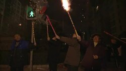 Citizens hold Roman candles and other fireworks on a Beijing street. Stock Footage
