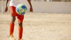 Brazilian boy juggles and stalls soccer ball on foot Stock Footage