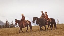 TS Three herdsmen riding horses on a mountain Stock Footage