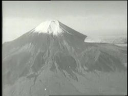 The Enola Gay fighter plane flies past Mt. Fuji. News Clip