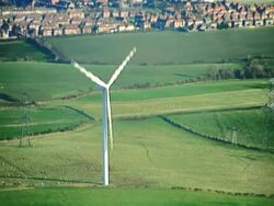 Aerial view of a wind turbine in countryside. NTSC, PAL Stock Footage