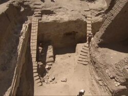 High Angle, crane - Workers use plank ladders to enter an archeological dig in Egypt Stock Footage