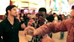 Friends dance, point up to light-show on Fremont Street in downtown Las Vegas Stock Footage