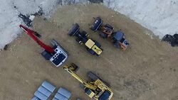 Heavy Machinery Aerial View Rising high over Construction Zone site of New Luxury Apartment Complex Stock Footage