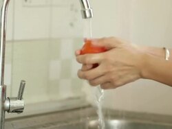 Hands washing tomato Stock Footage