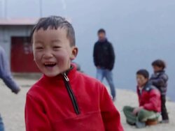 CU Shot of children laugh in streets of Namche Bazarre / Namche, Nepal Stock Footage