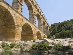 MS Side POV LA PAN Shot of river Gardon with Pont du Gard bridge / Pont du Gard, Provence, France Stock Footage