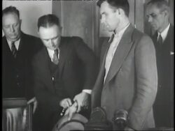 Lawyers lead accused Lindbergh baby kidnapper Bruno Hauptmann into the courtroom. News Clip