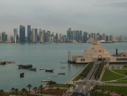 Elevated view over the Museum of Islamic Art and the Dhow harbour to the modern skyscraper skyline, Doha, Qatar, Middle East Stock Footage
