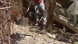 A man balancing on a slackline while reading a book and then falling. - Slow Motion Stock Footage