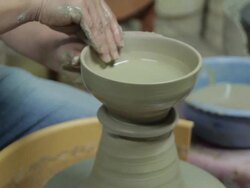 Shot of holding clay and making pottery shape with hands and pottery wheel Stock Footage
