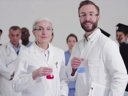 Scientists standing in front of diverse crowd with different careers Stock Footage