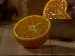 High speed knife cutting orange in half Stock Footage