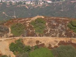 Aerial ZI TS of mountain bike cyclist / Topanga State Canyon, California, United States Stock Footage