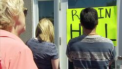 Protesters putting sign on Walter Palmer's surgery News Clip