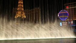 The Bellagio fountain on Las Vegas Boulevard at dusk, Las Vegas, Nevada, USA, probably the most unsustainable city in the world, it uses vast quantities of water in the middle of a desert and vast amounts of energy to power this most profligate of cities. Stock Footage