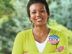 MS Portrait of Smiling Woman Wearing VOTE Button / Richmond, Virginia, USA Stock Footage