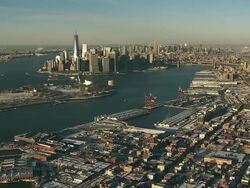 Aerial flying over Red Hook, Brooklyn towards south end of Manhattan covered in snow Stock Footage