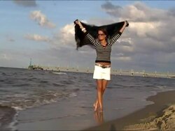Young woman at the beach in windyd day Stock Footage