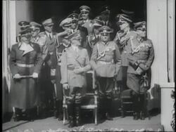German Nazi soldiers goose step past Adolf Hitler and military officials and give the Fascist salute. News Clip