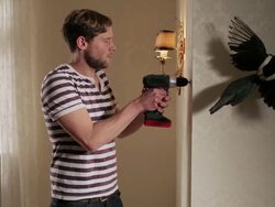 MS Man drilling into wall and hitting  pipe causing  leakage / Berlin, Germany Stock Footage