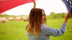 Young woman flying American flag Stock Footage