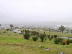 "WS PAN Street with green field and city / Montevideo, Uruguay" Stock Footage