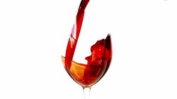 Slow motion pouring red wine on white background Stock Footage