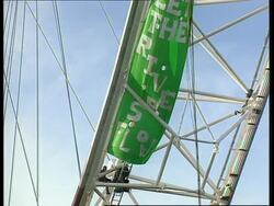 UK: LONDON:  ACTIVISTS SCALE MILLENIUM WHEEL News Clip