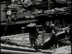 1930 B/W MONTAGE men walking up and down ramp loading sampans, PAN across riverbank full of boats / Hong Kong
 Stock Footage