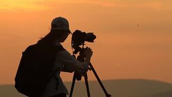 silhouette of women take a photo with mountain at sunset . Stock Footage