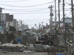 Destruction caused by tsunami after magnitude 9 Tohoku earthquake, north east Japan, March 2011. Close up of street completely filled with debris from tsunami Stock Footage