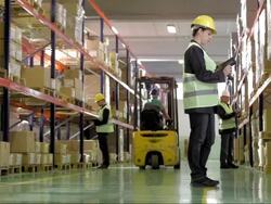 Female Warehouse Worker Scans Boxes Stock Footage