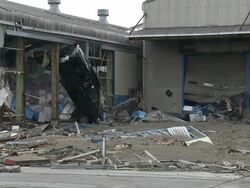 Destruction caused by tsunami after magnitude 9 Tohoku earthquake, north east Japan, March 2011. Car lies on its front inside industrial building in Ishinomaki City port, Miyagi Prefecture Stock Footage