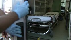 EMTs carry equipment into an ambulance. Stock Footage