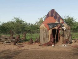 WS View of woman Imba with her children in front of their hut / Imba Village, Namibia Stock Footage
