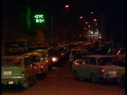 Fall of the Berlin Wall: cars wait to cross border Stock Footage