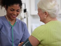 MS PAN Nurse Checking Blood Pressure of Senior Patient in Medical Office / Richmond, Virginia, USA Stock Footage