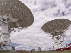 Long Shot static - Two satellite dishes point skyward / New Mexico, USA Stock Footage