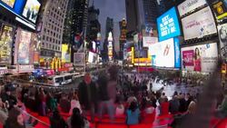 Tourists on bleachers watch the bright lights in New York City's Times Square. Stock Footage