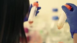 Scientist a look at test tube with liquid sample in laboratory, Slow motion Stock Footage