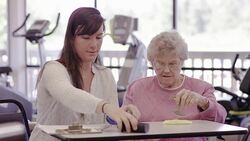 Occupational therapist working with a geriatric patient in a clinic Stock Footage