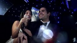 Hollywood couple talk and laugh in back of limousine as paparazzi snap photos outside at awards show Stock Footage
