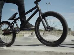 Teenage boys doing BMX tricks in skate park Stock Footage