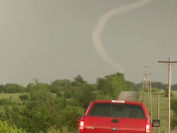 MS Shot of thin tornado moving across countryside with truck / Marietta, Oklahoma, United States Stock Footage