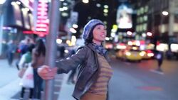 Young woman in love swings around street-sign in the heart of Times Square Stock Footage